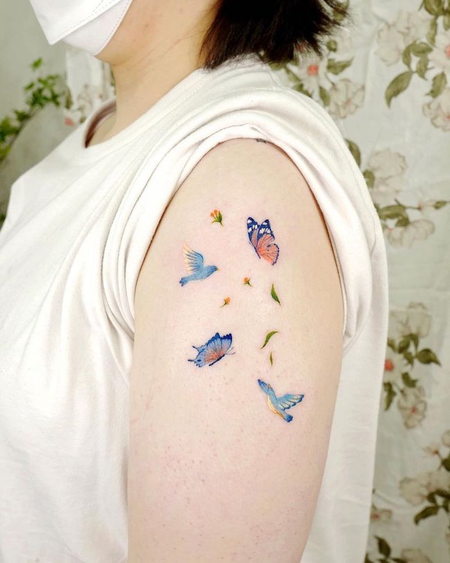 Butterfly and birds colorful sleeve tattoo by @ovenlee.tattoo