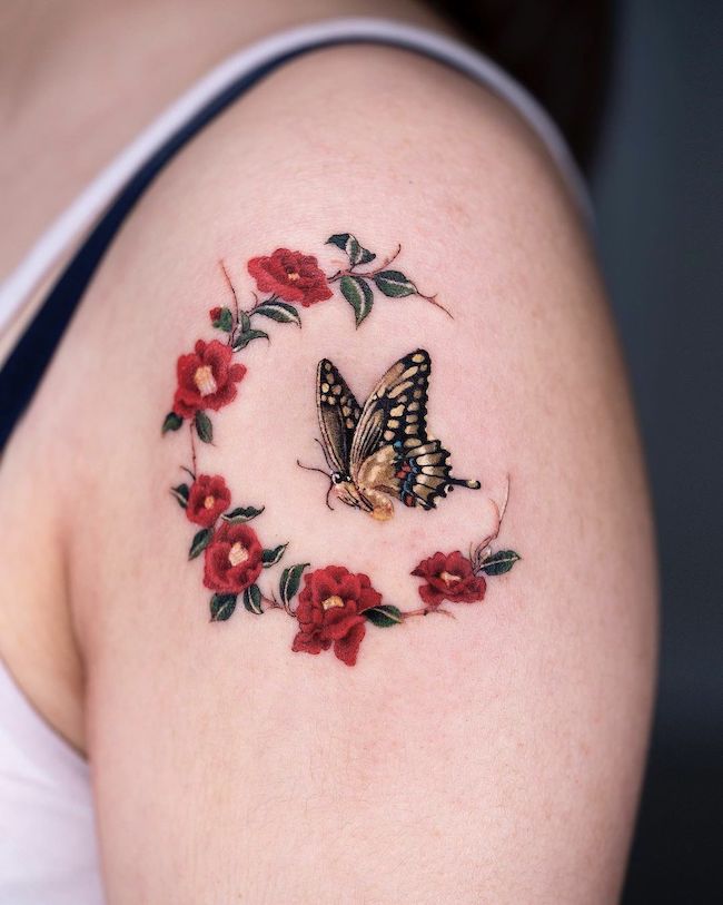 Butterfly and roses tattoo by @oozy_tattoo