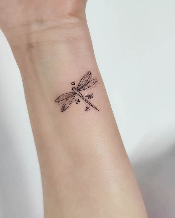 Cute and small dragonfly wrist tattoo by @l.ink_tattoos