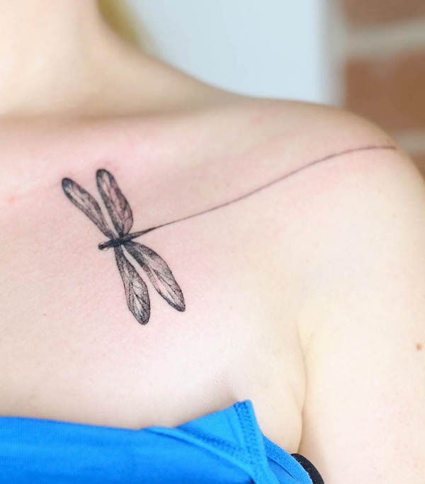 Dragonfly shoulder and collarbone tattoo by @michelle.wilinski