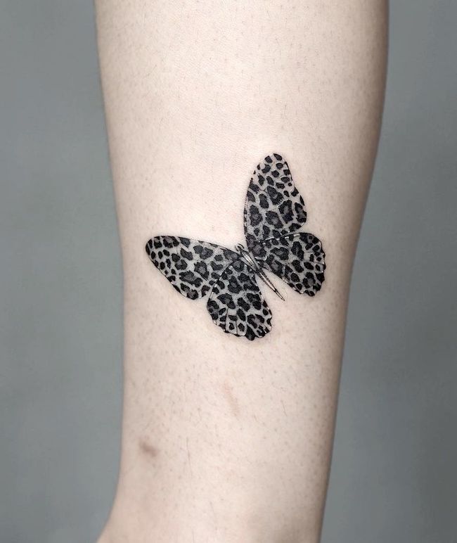 Leopard butterfly leg tattoo by @ura.ttt