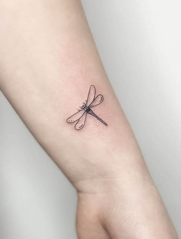 Minimalist dragonfly wrist tattoo by @frau.ines_