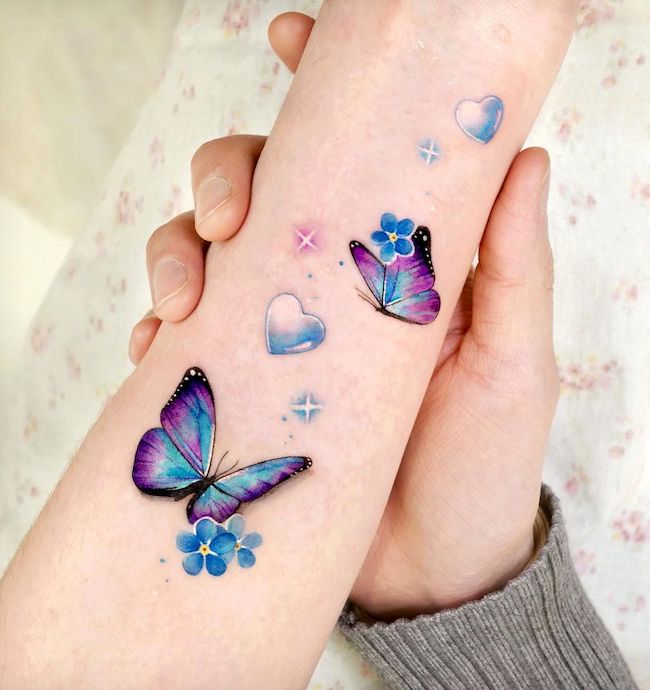 Shape of heart butterfly wrist tattoo by @songe.tattoo