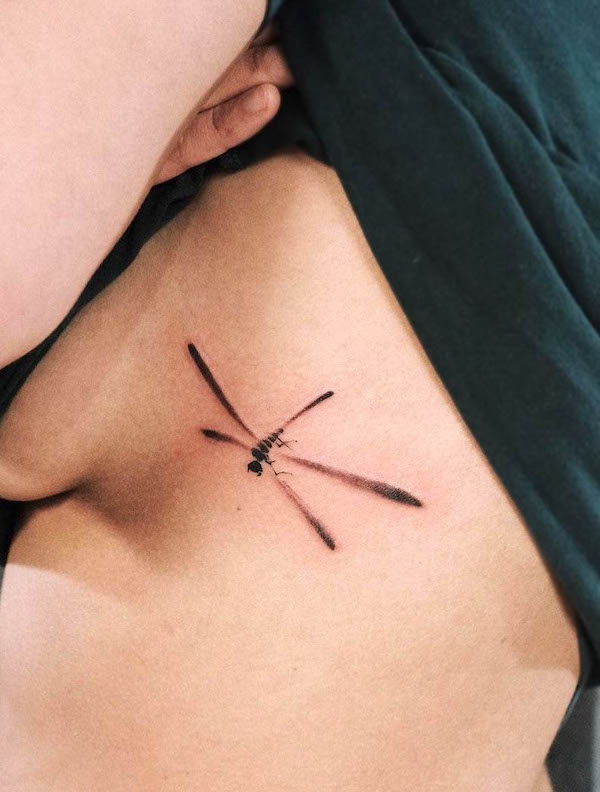 Simple dragonfly rib tattoo by @hantao_l