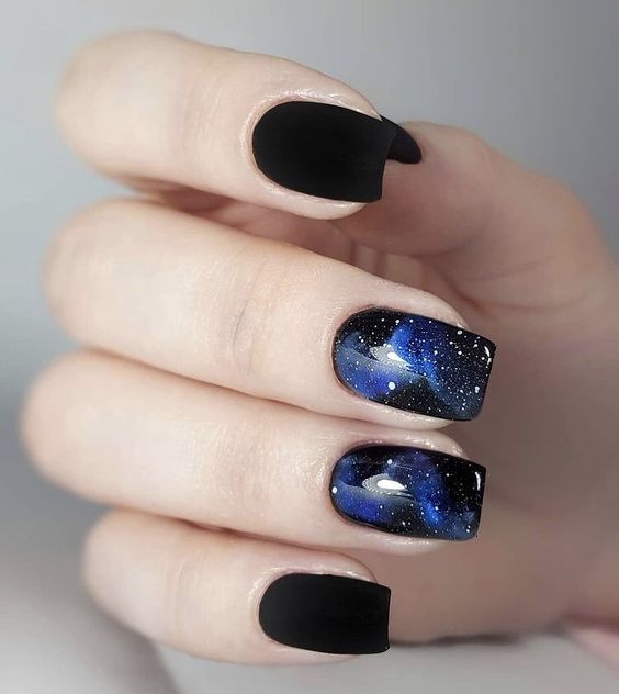 Matte black nail color and galaxy nail art on medium tapered square nails
