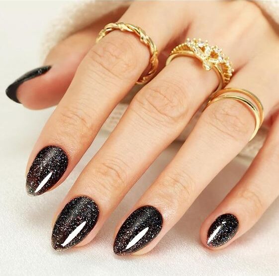 Black glittery nail polish on medium almond nails