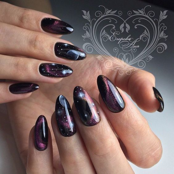 Combination of black and purple nail colors with galaxy-inspired nail design on long almond nails