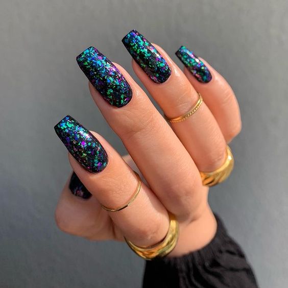 Black nail color with blue and green glitters on long tapered square nails