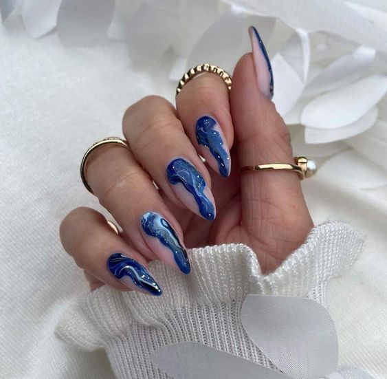 Blue marbled galaxy nail art on long stiletto nails