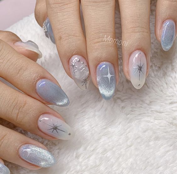 Chrome pale blue nail color with celestial elements nail designs on medium almond nails