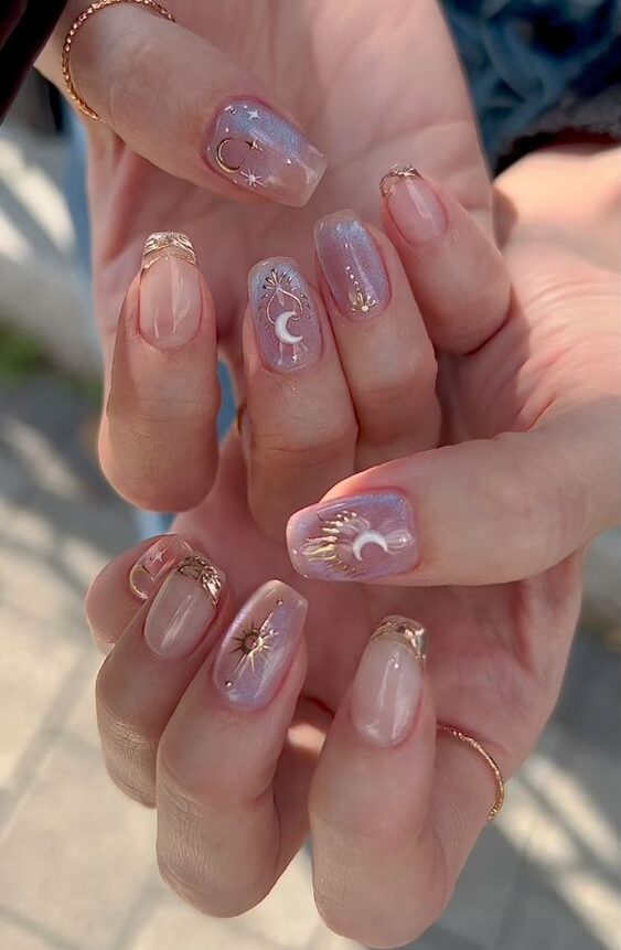Clear medium coffin nails with gold celestial elements nail designs