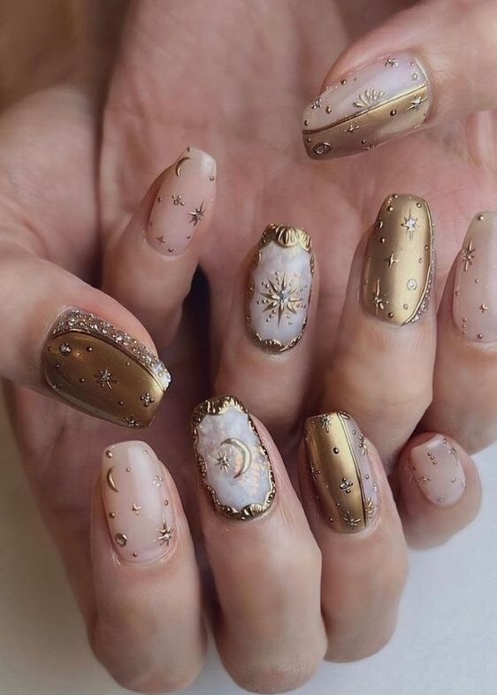 Clear and gold medium coffin shaped nails with gold celestial elements nail arts
