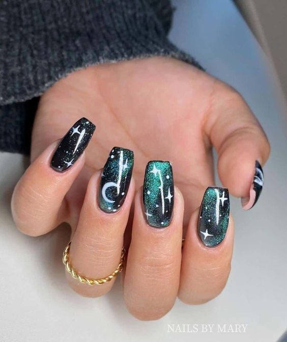 Combination of black and green galaxy-inspired nail art on long tapered square nails