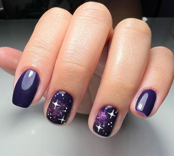 Deep purple nail color with galaxy nail art on short nails