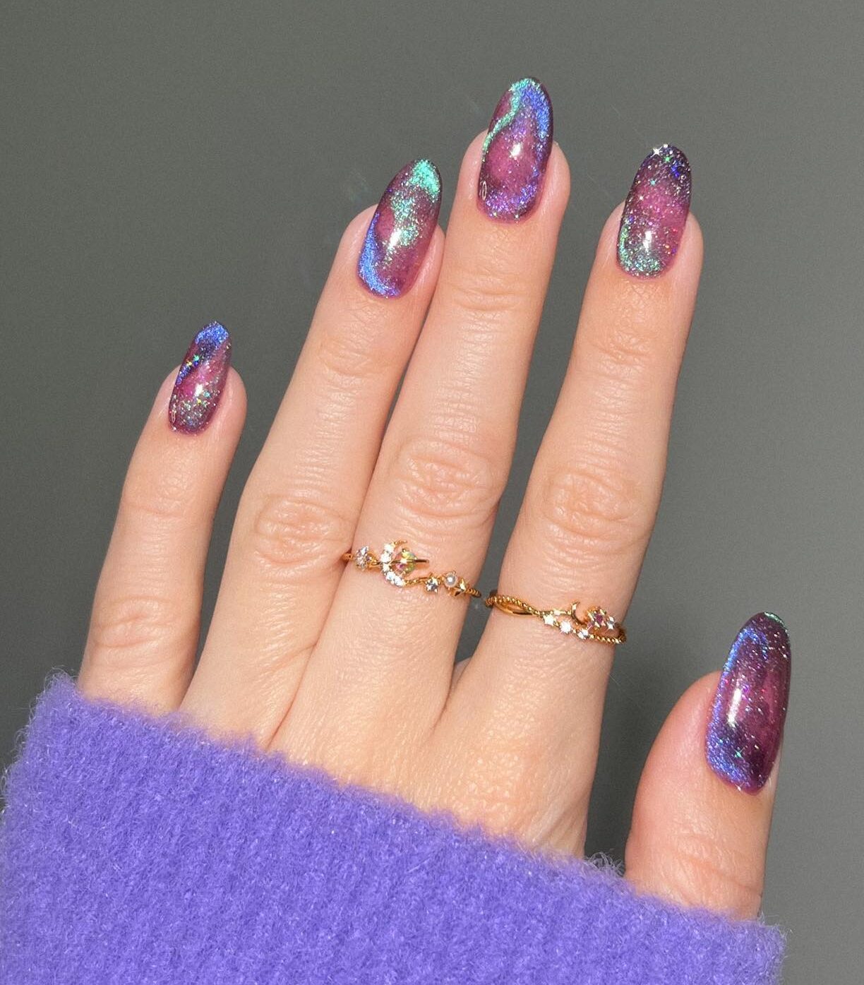 Chrome purple galaxy-inspired nail art on medium round nails
