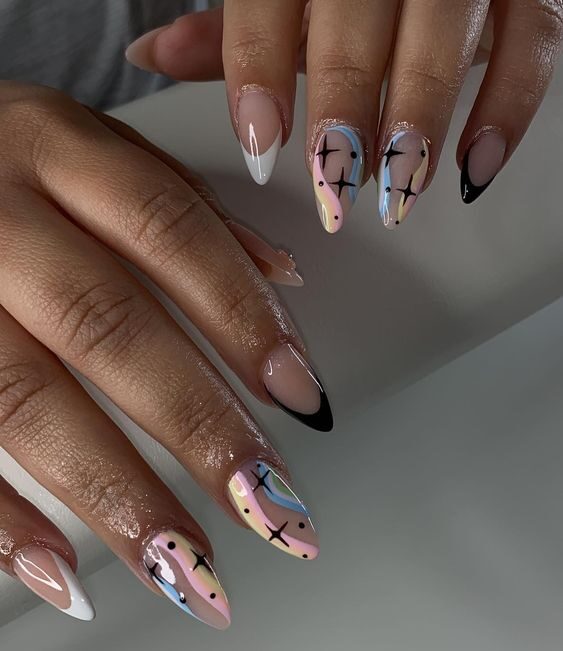 Pastel colored swirls with celestial elements nail designs on long almond nails