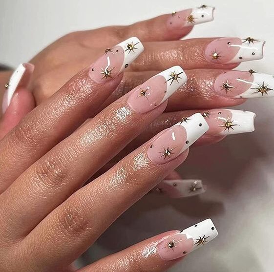 White French tips with gold celestial elements nail arts on long tapered square nails