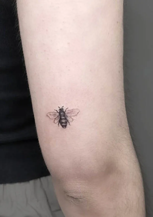 Tiny bee elbow tattoo by @kaleidoscopetattoostudio