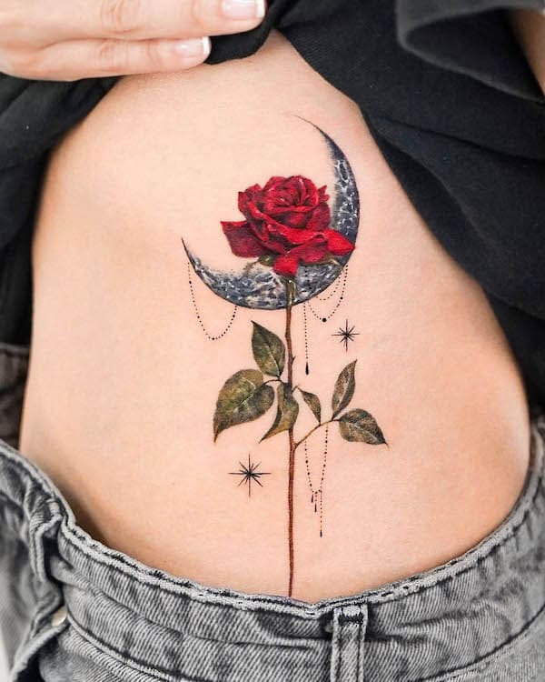 Rose and moon side waist tattoo by @o.ri_tattoo