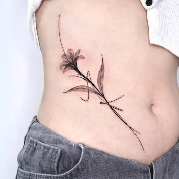 Abstract black flower rib tattoo by @sixtenism