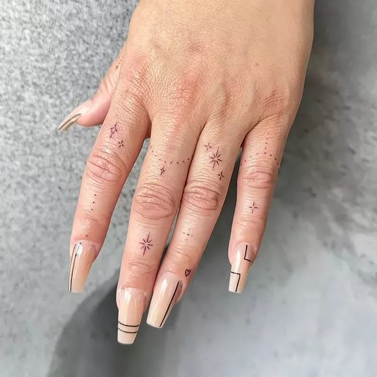 Celestial finger tattoos