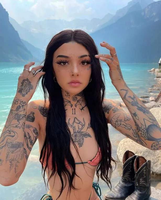 Keaton Belle poses in a bikini in front of some mountains
