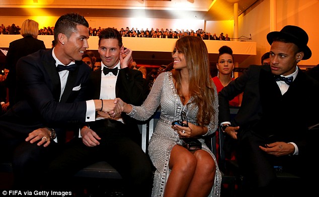 This picture of Ronaldo shaking hands with Antonella Roccuzzo with an awkward looking Messi in between went viral. Messi's Barcelona teammate Neymar (far right) appears to have his eye on the situation 