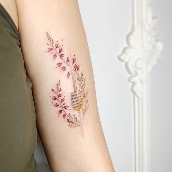 Mini, small tattoo of feminine flowers roses with honey on the arm