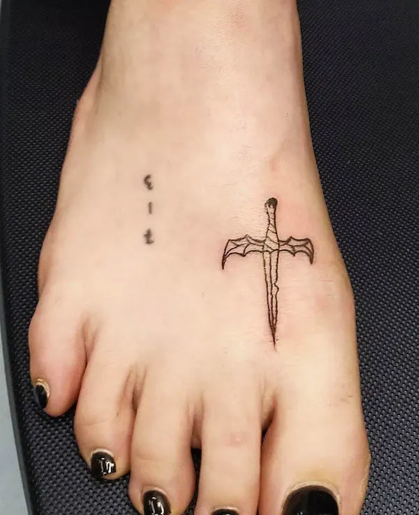 Tiny sword foot tattoo by @sanctuaries.ttt