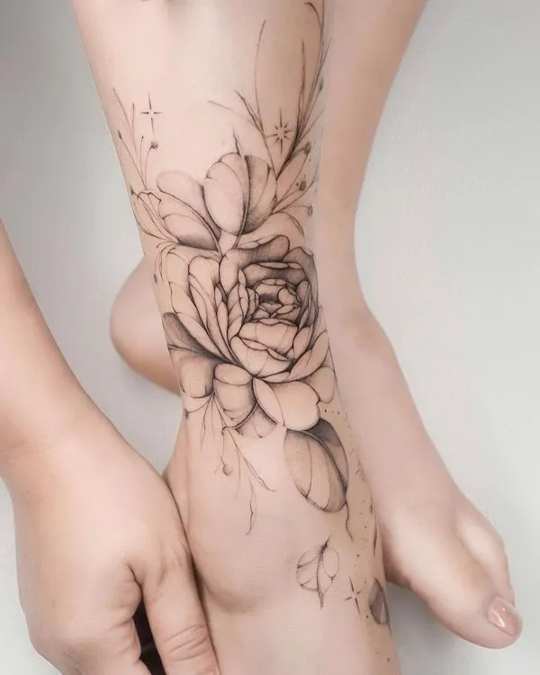 Greyscale flower foot tattoo by @lasstattoo