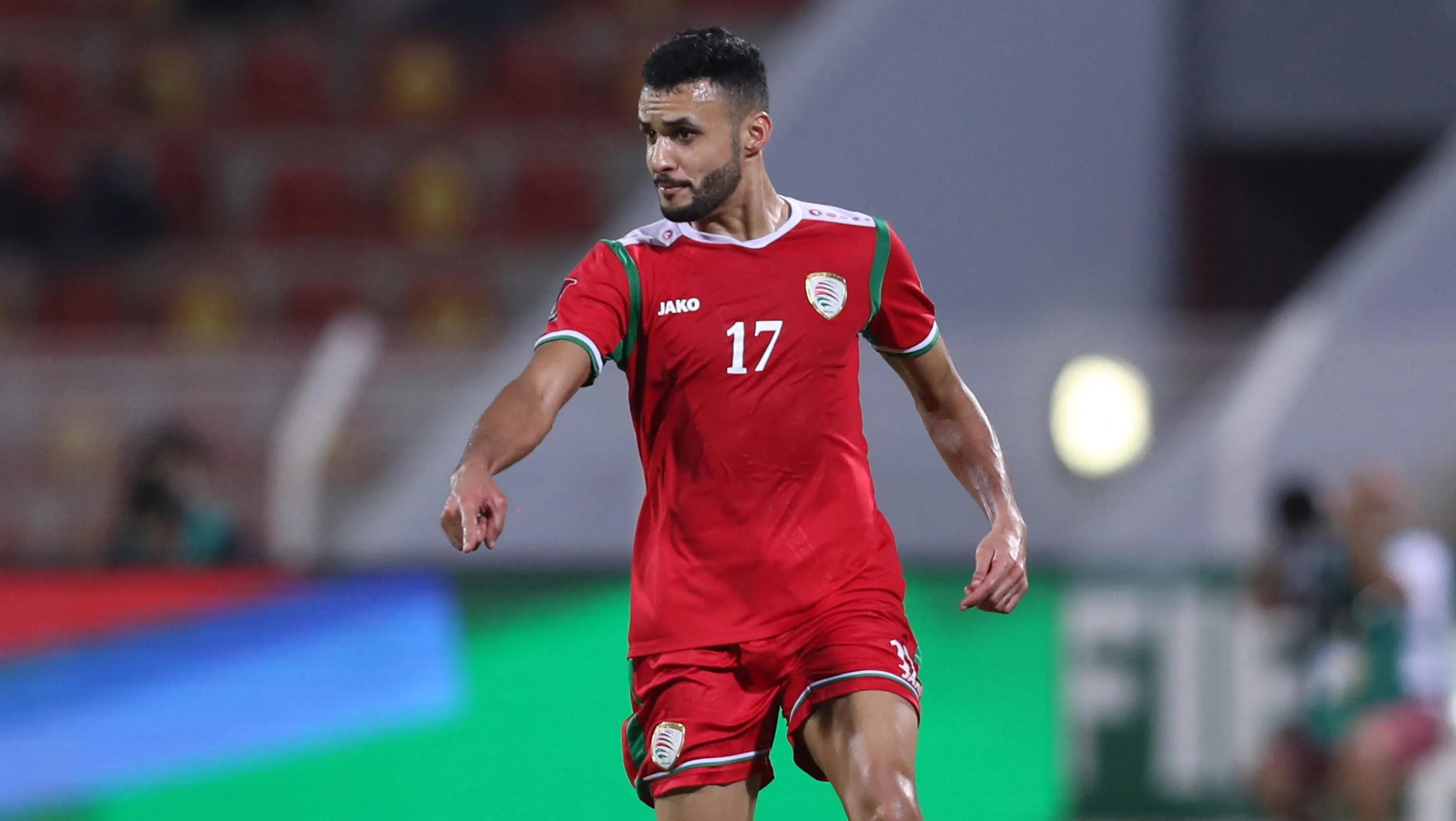 Oman's defender Ali al-Busaidi runs with the ball during the 2022 Qatar World Cup Asian Qualifiers football match between Oman and Japan, at the Sultan Qaboos Sports Complex stadium in the capital Muscat, on November 16, 2021. (Photo by Haitham AL-SHUKAIRI / AFP) (Photo by HAITHAM AL-SHUKAIRI/AFP via Getty Images)