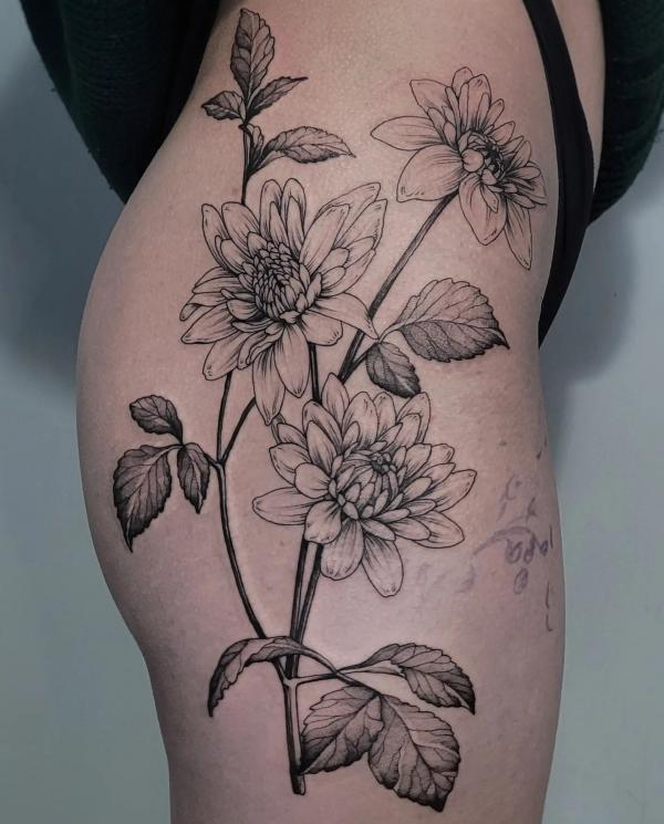 Black and grey dahlia tattoo on the side of hip