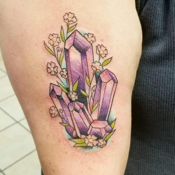 Crystal with flowers tattoo on upper arm