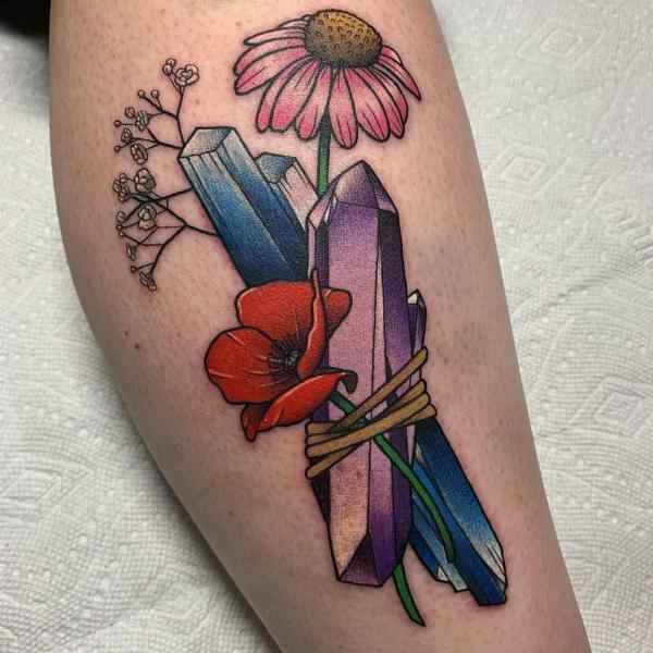 Crystal with poppy and daisy tattoo