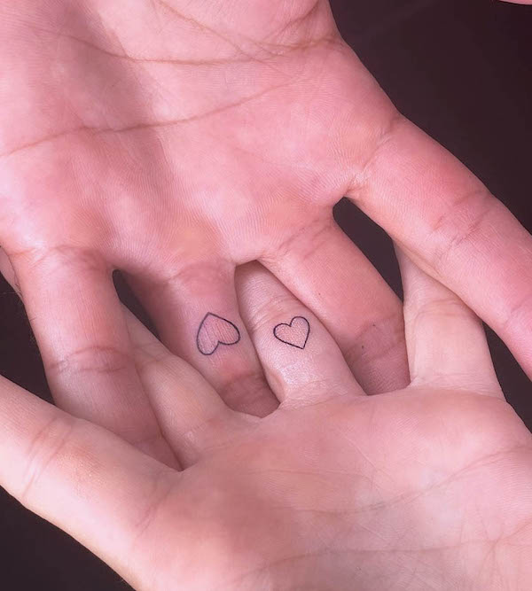 Small hearts wedding ring tattoos by @isisinked