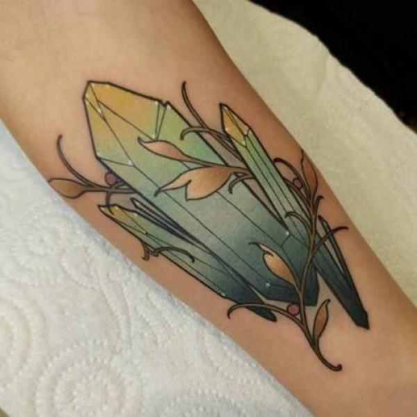 crystal and plant tattoo forearm